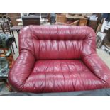 A tan leather 2 seat sofa