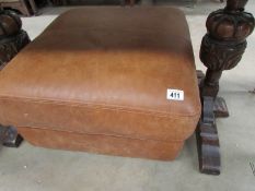 A large brown leather foot stool/pouffe