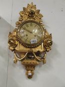 An ornate gilded wall clock