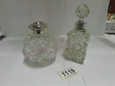 2 silver topped perfume bottles