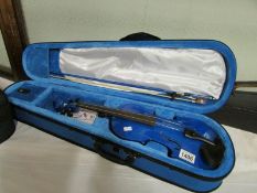 A modern cased violin and bow