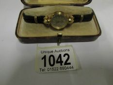 A Titus 18ctgold wrist watch with attach