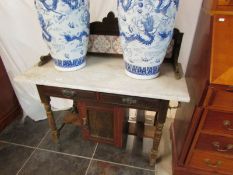 A Victorian wash stand with tiled back a
