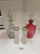 A cranberry glass jug, a glass decanter