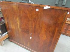 A mahogany veneered bookcase/cabinet