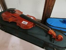 A modern cased violin and bow