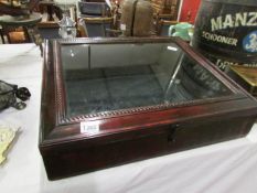 A glazed table top display cabinet