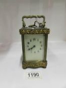 An ornate French brass carriage clock