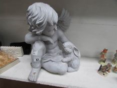 A cherub with rabbit garden figure