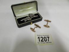 A pair of silver cuff links and a pair o