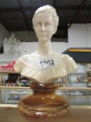 A bust of a lady on alabaster base