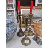 A pair of brass candlesticks and one oth