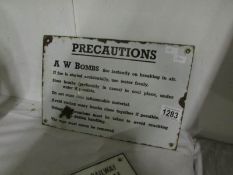 An enamel sign 'Precautions - A W bombs'