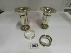 A pair of silver vases and 2 silver napk
