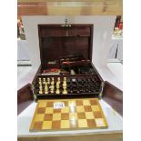 A Victorian rosewood games box containin