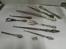 9 silver handled items including button