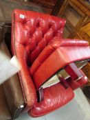 A red leather chair and stool