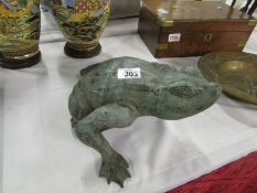 A bronze garden ornament of a frog