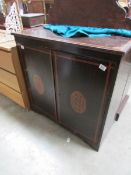 A mahogany inlaid cabinet