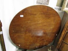 A circular mahogany tip top table