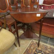 A Triangular mahogany occasional table with drop sides