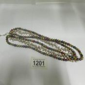 A triple row of multicoloured cultured pearls