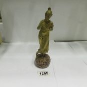 A bronze figure of a girl on marble base