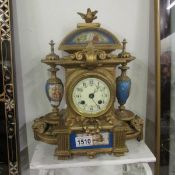 A French bronze mantel clock with porcelain panels