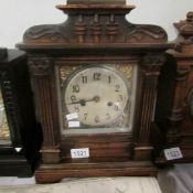A wood cased mantel clock