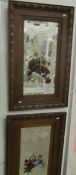 A pair of oak framed bevel edged mirrors with hand painted floral decoration