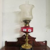 A Victorian oil lamp with cranberry glass font,