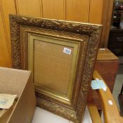 A gilt picture frame with glass