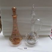 A hand  decorated claret jug and a 1950's coloured glass decanter