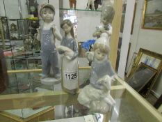 4 Lladro figurines including children at play and holding animals