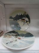 A pair of winter scene wall plaques