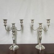A pair of silver plated candelabra (Welsh) one has small indent