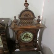 A wood cased mantel clock