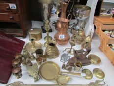 A mixed lot of brass and copper including candlesticks, jugs,