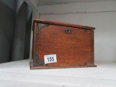 An oak box with drop front