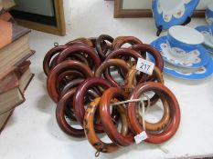 A quantity of Victorian wood and bamboo style curtain rings