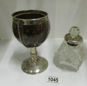A white metal and coconut goblet and a scent bottle