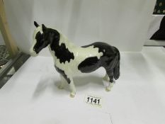 A Beswick black and white horse