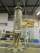 A brass trench art shell case table lamp decorated in relief with grapes,