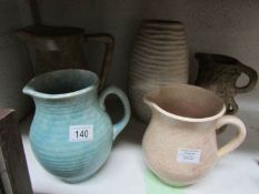 4 jugs and a vase,