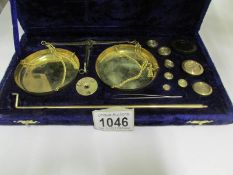 A cased set of precious metal weighing scales