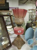 A Victorian oil lamp (shade badly a/f)
