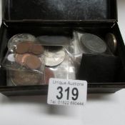 A mixed lot of coins in a metal cash box