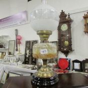 A Victorian oil lamp with mottled glass font