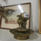 A brass inkwell in the form of a griffin