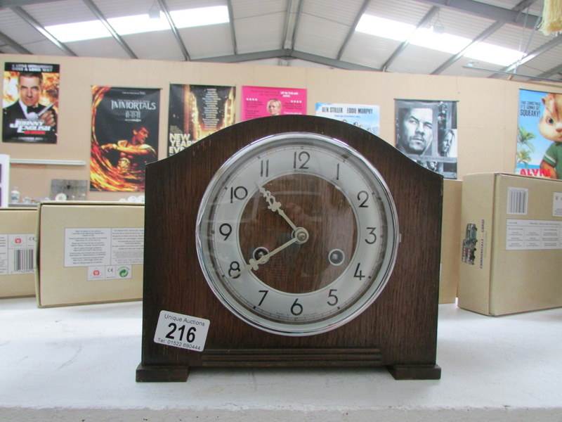 An oak chiming mantel clock with key